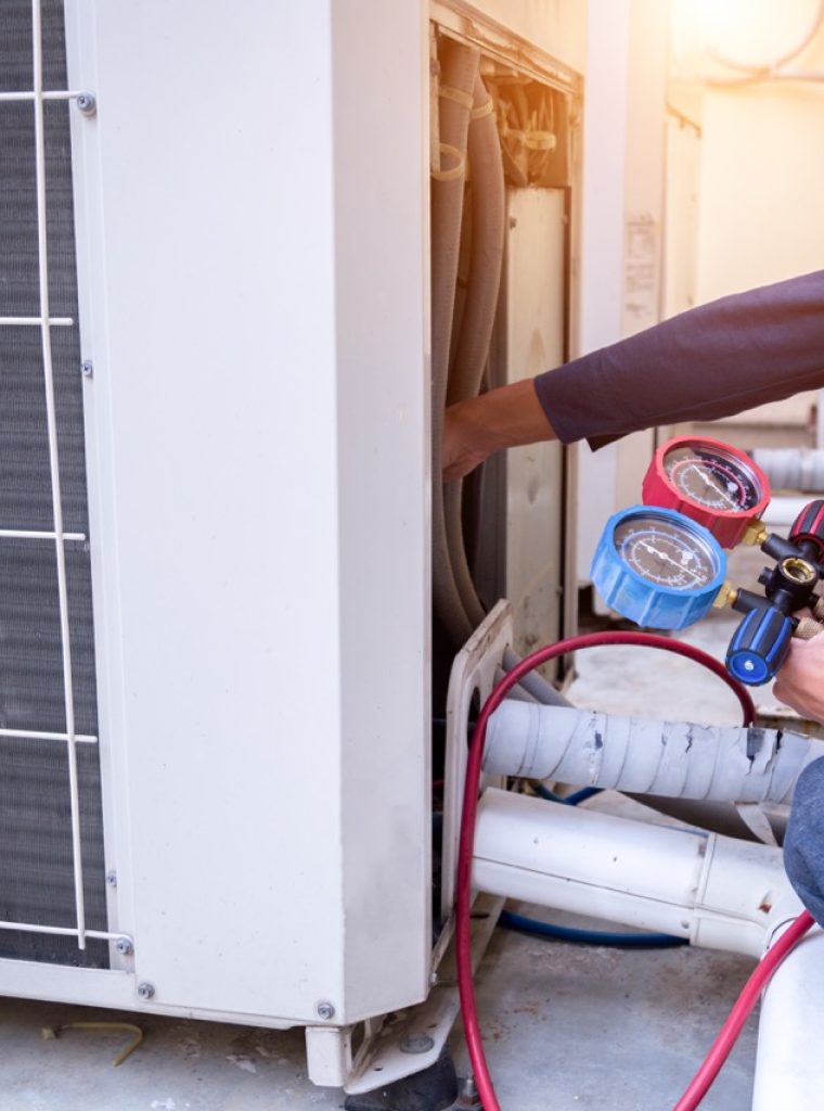 Technician is checking air conditioner ,measuring equipment for filling air conditioners.